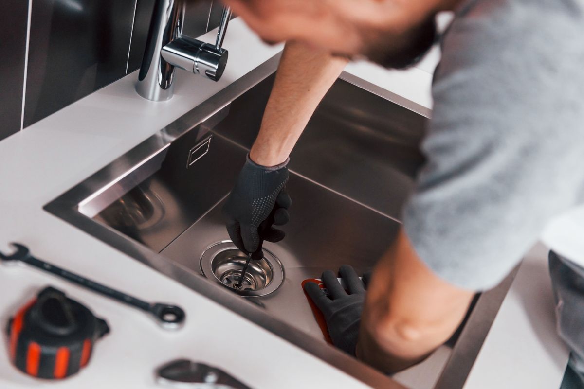 plumber fixing sink drain