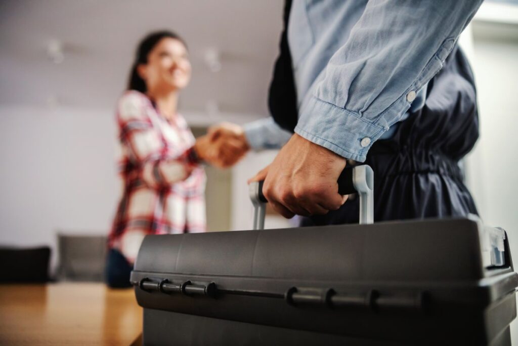 plumber shaking hands with client