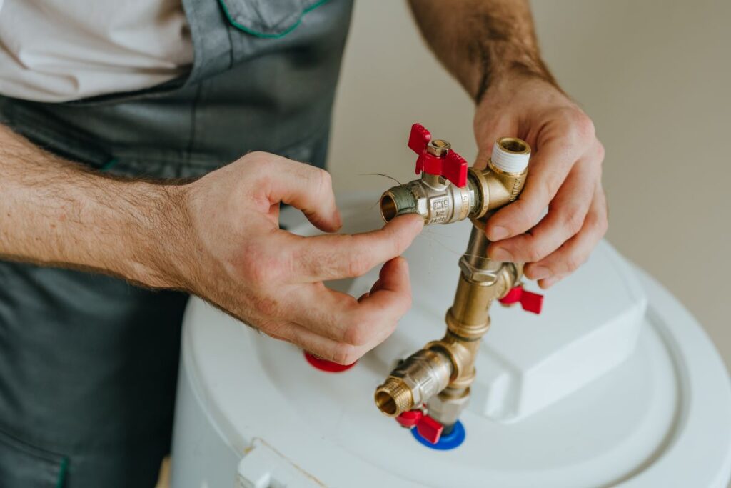 worker fixing water heater